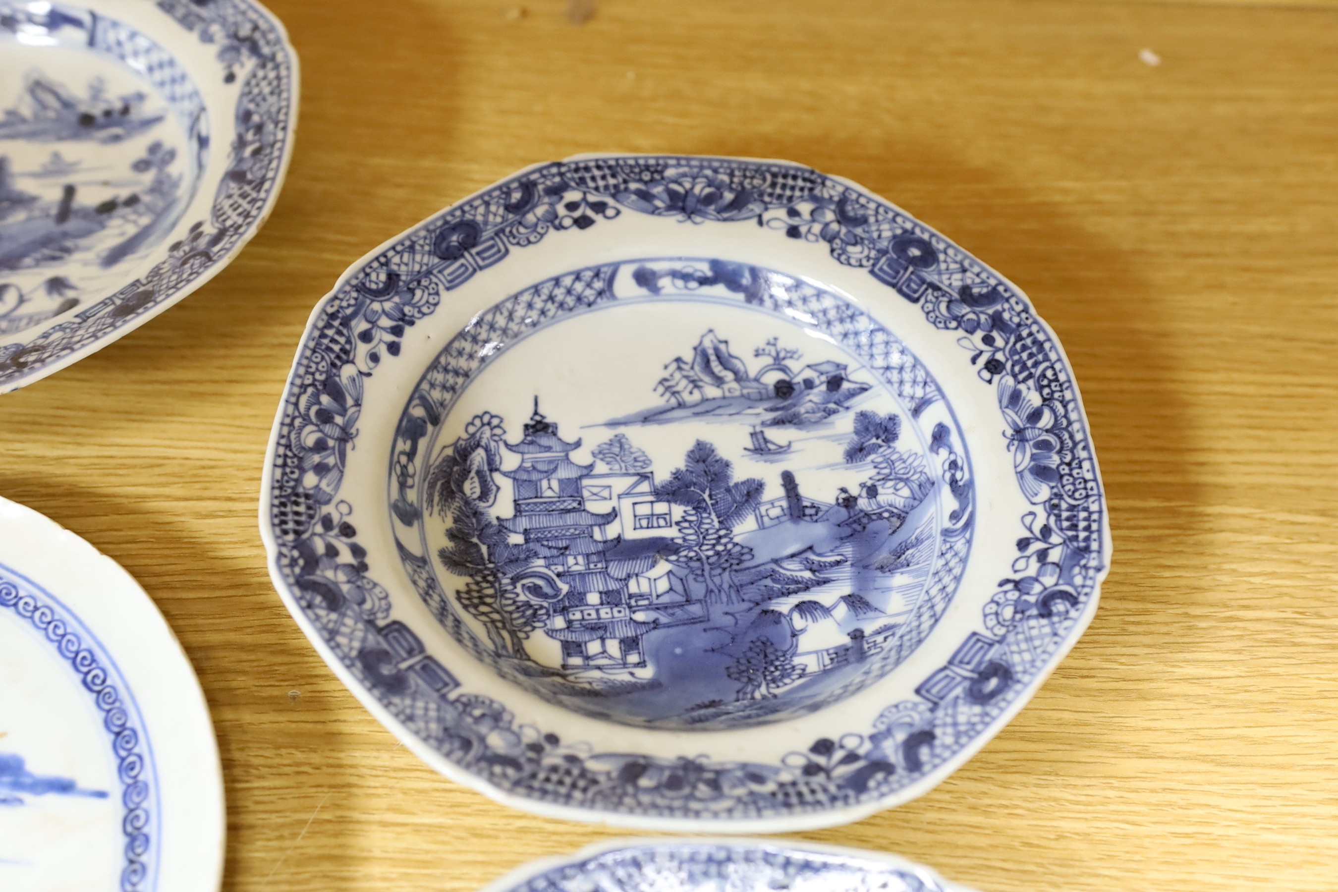 A selection of severn 18th century Chinese export blue and white dishes, largest 35cm wide